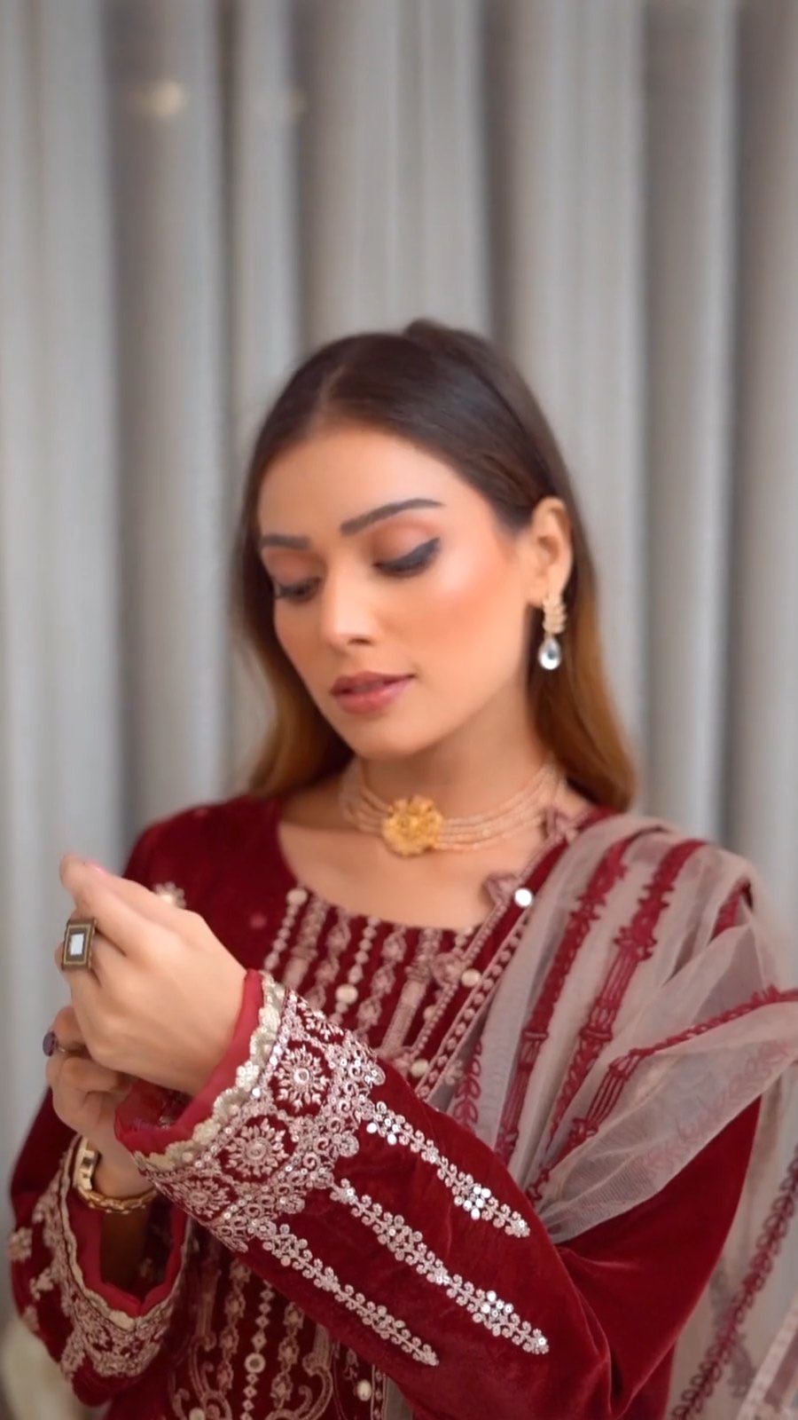 Maroon embroidered salwar set worn with a striped dupatta